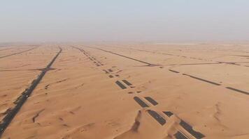 An aerial view of a desert with paved road in the middle video