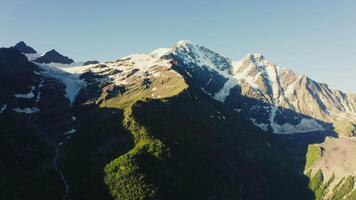 Snow capped peaks rise above the mountain range. video
