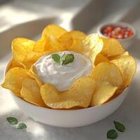 A bowl of chips with dip and herbs photo