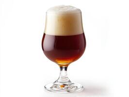 Craft beer served in a glass with creamy foam on top photo