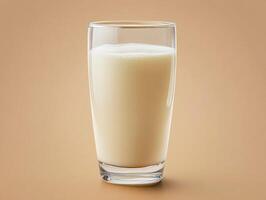 Creamy beverage in a clear glass on a simple background photo