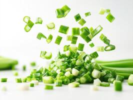 Chopped green onions in mid-air creating a vibrant kitchen moment photo