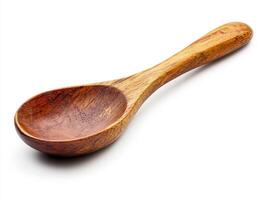Wooden spoon on a white background for cooking and serving photo