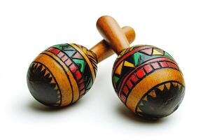 Colorful maracas designed with traditional patterns on wooden surface photo