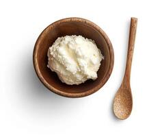 Homemade cream cheese in a wooden bowl with a spoon photo