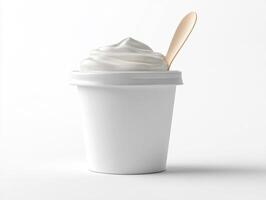 Simple white cup filled with creamy dessert topped with a spoon photo