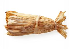 Delicious traditional tamale wrapped in corn husk ready to be served photo