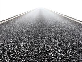 Endless asphalt road disappearing into foggy horizon photo