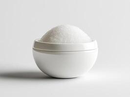 White sugar in a ceramic bowl on a plain surface photo