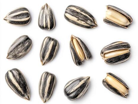 Close-up of sunflower seeds and shells arranged on a surface photo