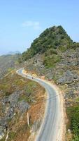 Aerial view of motorcyclists riding on Ha Giang Loop on sunny day in Vietnam. video