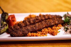 A plate with meat and rice on it photo