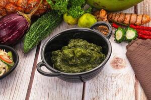 A table with a bowl of food and a bowl of vegetables photo