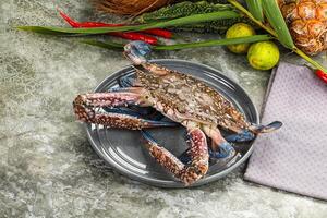 A crab on a plate with other food photo