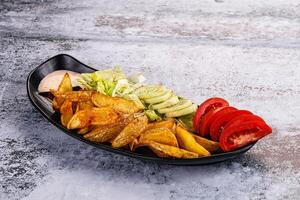 A plate of food with a side of salad photo