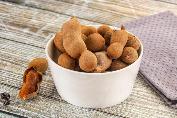 A bowl filled with nuts and a napkin on a table