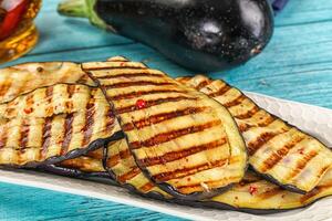 Grilled eggplant on a white plate photo