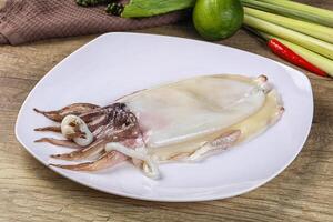 A plate with a squid on it and some vegetables photo