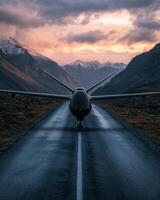 Drone on a runway in mountainous landscape at sunset photo