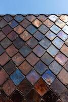 Iridescent roof tiles create a unique textured pattern photo