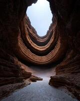 Dramatic view looking up from inside a deep canyon towards the sky photo