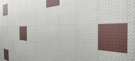 A modern wall featuring textured white tiles with scattered brown square patches, creating a geometric and structured design. The pattern adds depth, contrast, and a contemporary aesthetic appeal. photo
