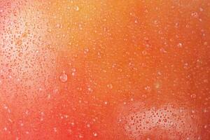 Red and yellow apples with water drops macro photo as a background. Fruit. Red apple peel.
