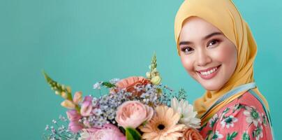 A woman wearing a hijab holding a bouquet of flowers photo
