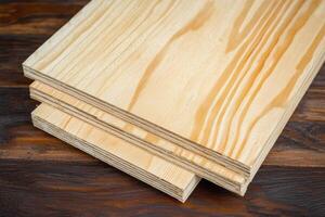 Clear Pine Boards Stacked Neatly on Dark Wood Surface Ideal for DIY Projects and Home Improvement Crafts photo