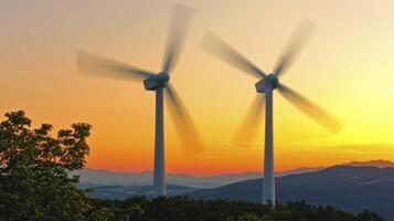 Rotating Wind Turbines at Sunrise Over Mountains photo