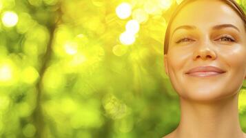 Happy woman smiling in natural sunlight with green blurry background in serene and peaceful environment photo