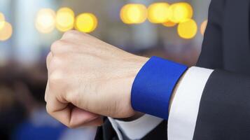 Elegant wristband on a man's hand with blurred background of a lively event or gathering photo