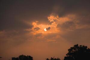 Dramatic and Mesmerizing Sunset Through Clouds with Rays of Light Illuminating the Sky photo
