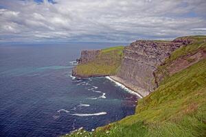 Breathtaking view of the Cliffs of Moher overlooking the Atlantic Ocean in Ireland 6 photo