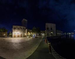 Historic souk at Dubai Creek at night with illuminated buildings and water reflections 1 photo