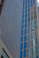 Close up of modern glass facade reflecting blue sky in Frankfurt 5 photo