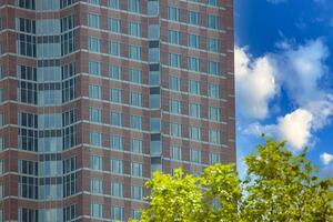 Close up of modern glass facade reflecting blue sky in Frankfurt 6 photo