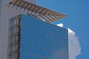 Close up of modern glass facade reflecting blue sky in Frankfurt 7 photo