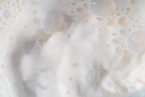 Milk water liquid white color drink and food texture background, Beautiful natural caw milk wave and bubble splash texture with macro on top view, Healthy photo