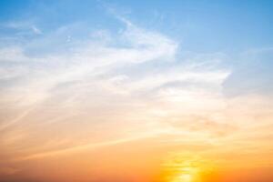 Beautiful , luxury soft gradient orange gold clouds and sunlight on the blue sky perfect for the background, take in evening,Twilight, Large size, high definition l photo