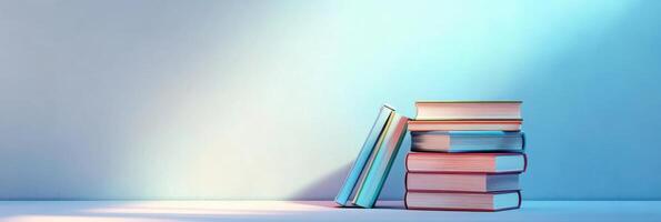 Stack of colorful books leaning against a minimalist background for education concept photo