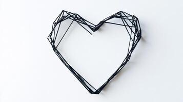 Geometric black wire heart shaped wall art on white background photo