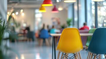 Colorful chairs in modern office with blurred background of people working photo