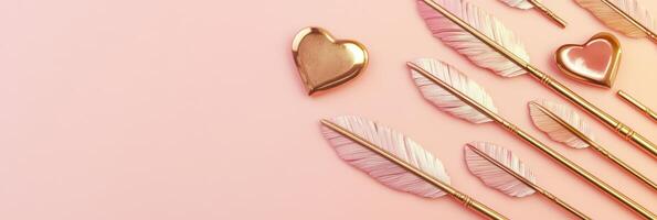 Pink background with gold heart and feather pens for romantic and creative concept photo