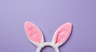 Minimalist Easter Bunny Ears on Soft purple for Spring. A trendy flat lay of rabbit ears, evoking a sense of freshness and seasonal joy, perfect for digital invitations, social posts photo