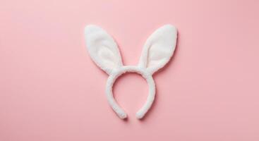 Springtime Easter Bunny Ears with Baby pink Backdrop. A whimsical representation of Easter festivities with soft-colored rabbit ears, bringing warmth and happiness to seasonal projects photo