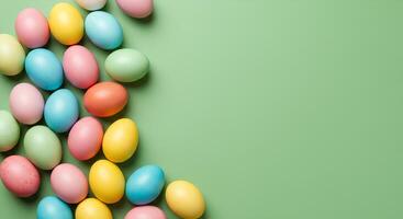colorful easter eggs isolated on light green background for Happy Easter promotional campaigns. Happy Easter flat lay background full of colorful eggs in celebration of the holiday. Happy easter frame photo
