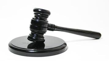 a black gavel on a white surface photo
