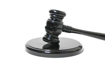 a black gavel on top of a white surface photo