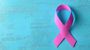 close up of pink cancer awareness ribbon on blue background photo